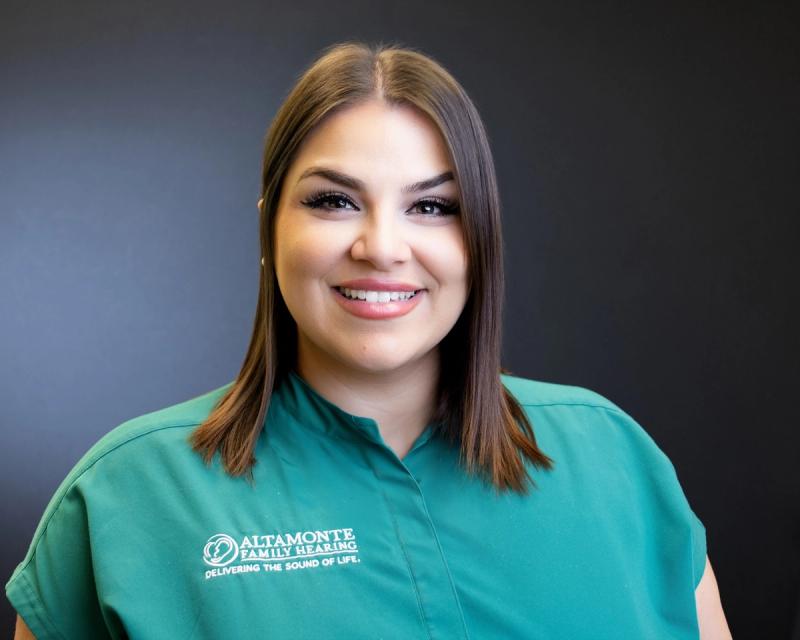 Grace Soto, Patient Care Coordinator, smiling in green scrubs