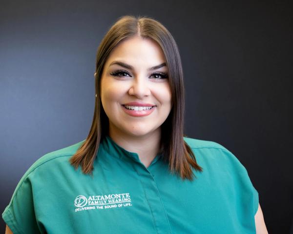 Grace Soto, Patient Care Coordinator, smiling in green scrubs