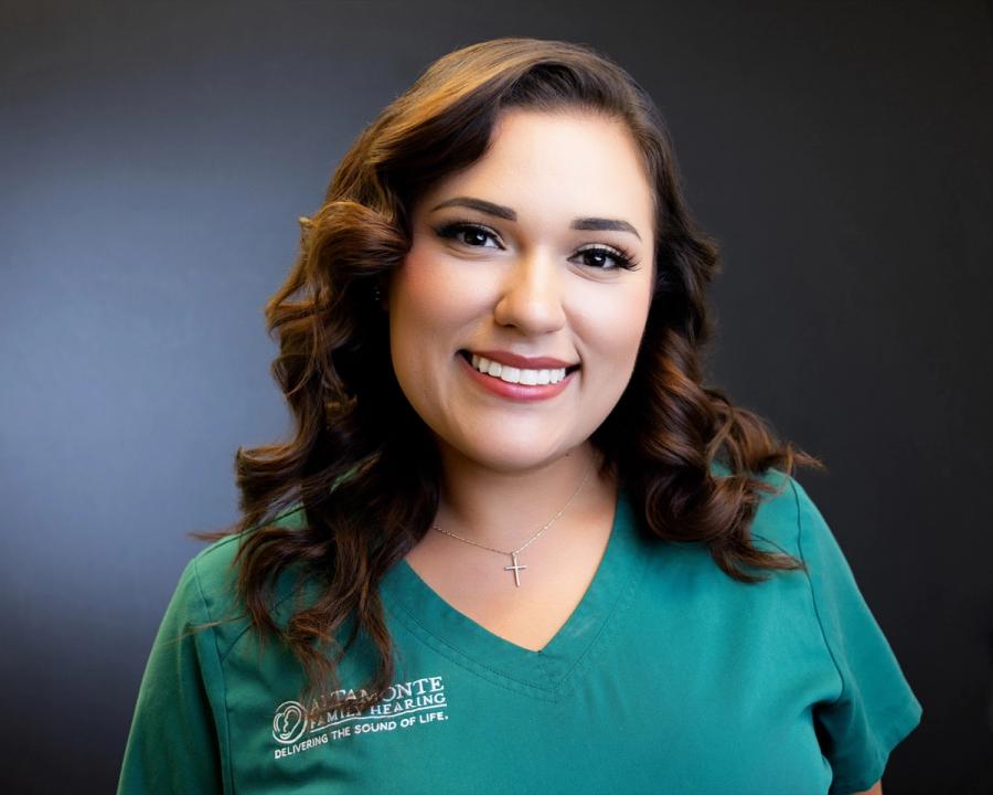 Francesca Natal, Patient Care Coordinator, smiling in green scrubs