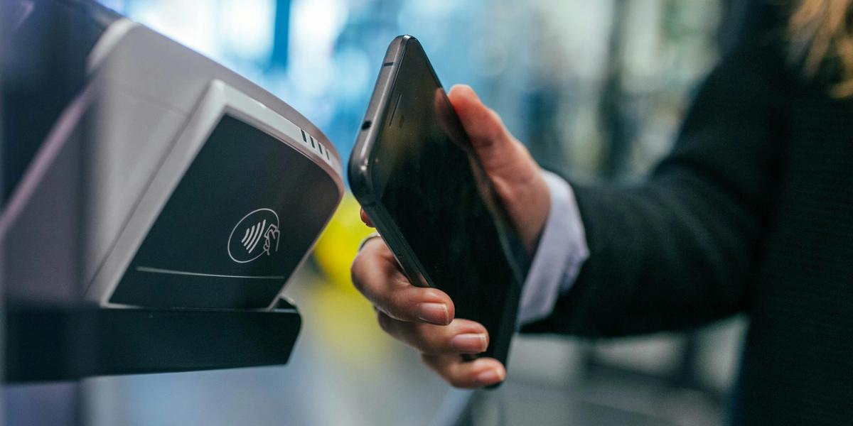 Person making a mobile phone contactless payment