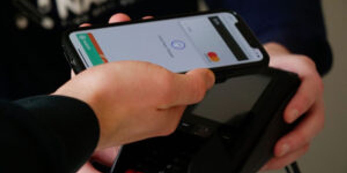 Person paying by mobile wallet