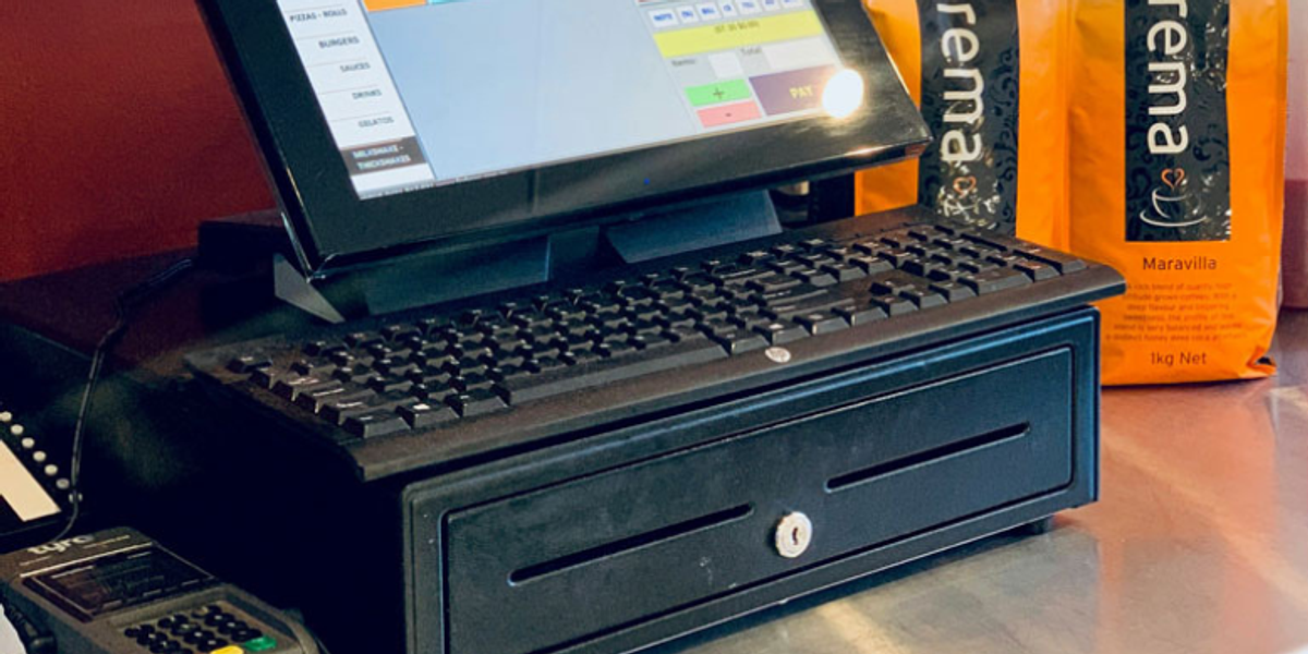 A point of sales in a shop with a payment terminal next to it