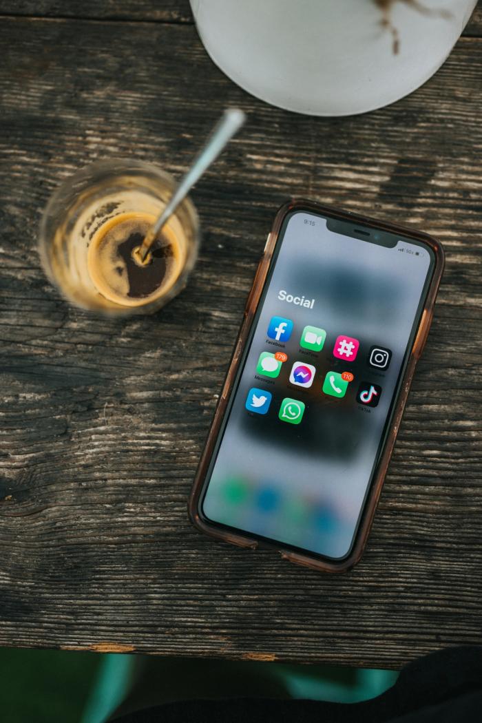 A mobile phone with social apps showing on the screen