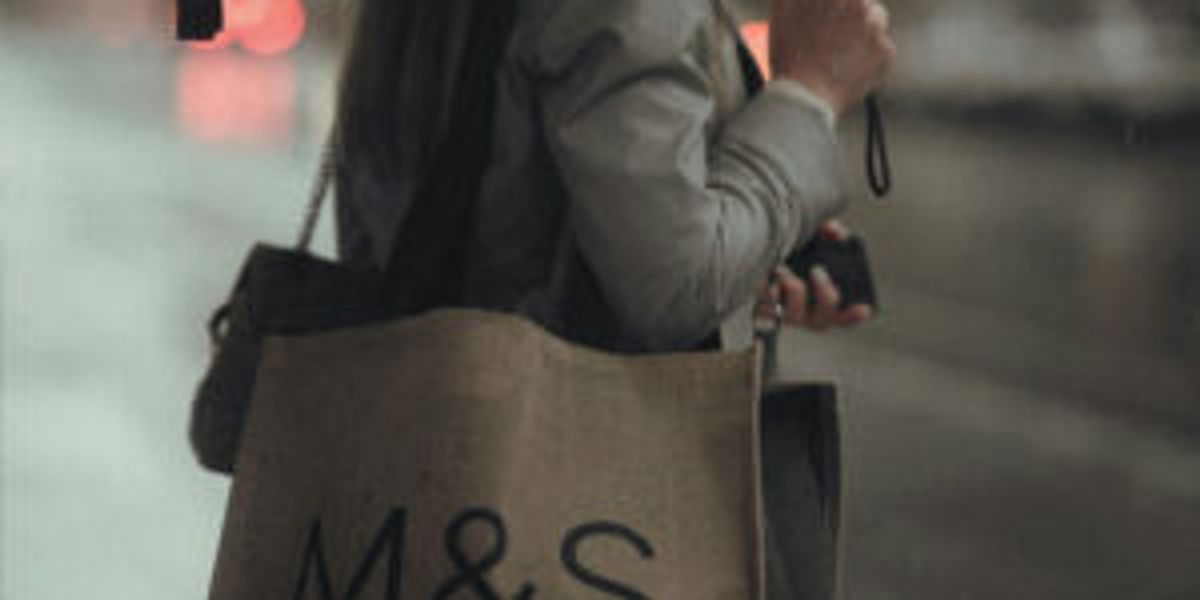 Person with an M&S bag over their shoulder