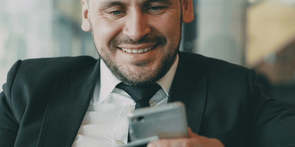 Person holding a mobile phone and payment card