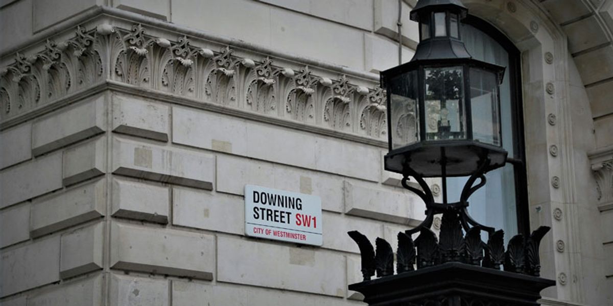 The Downing Street road sign on the side of a government building