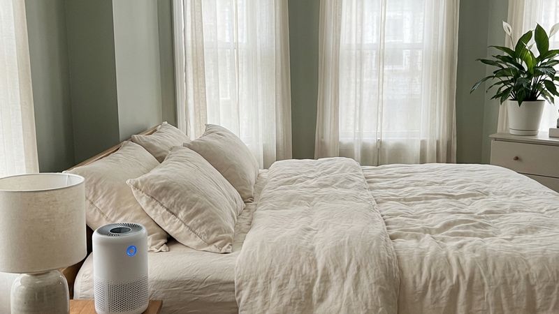Clean, peaceful bedroom with air purifier for healthy sleep environment