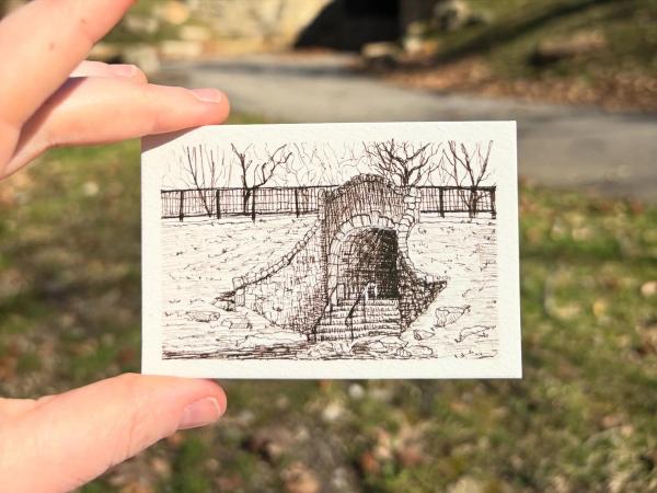 small sketch held between two fingers