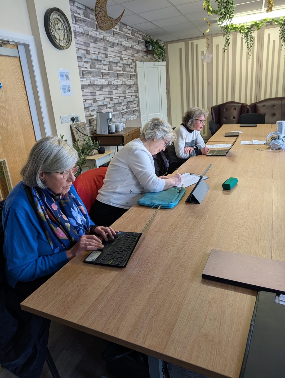 women sat around table with computers