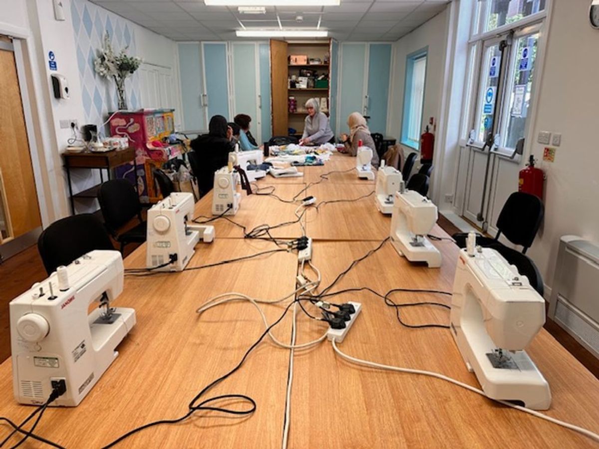 sewing machines and women around a table