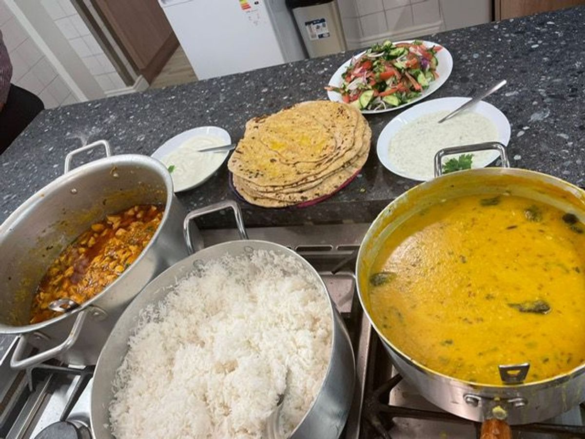 Image of rice and dhaal and bread in the kitchen