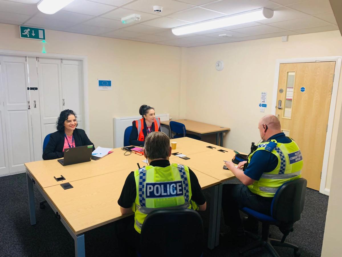 2 workers meeting with 2 police men