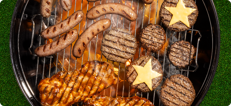 Pork steaks, brats and burgers on a grill