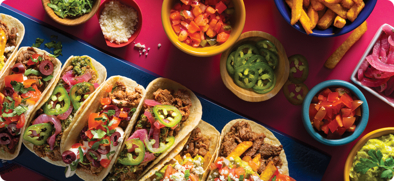 Several varieties of soft tacos on a blue tray