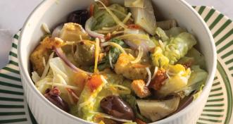A fresh Italian salad served in a white ceramic bowl.