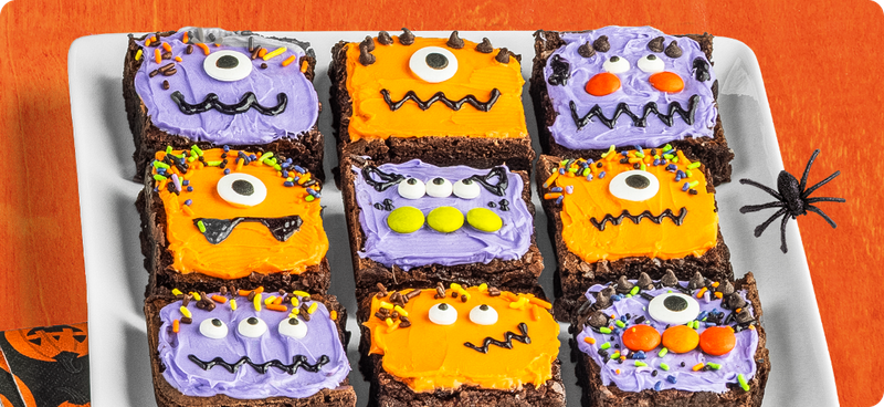 Brownies iced with purple and orange monster faces