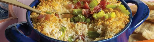 dip with freshly chopped jalapenos in a blue dish served with carrots