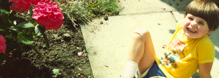 Old photo of child sitting on garden path