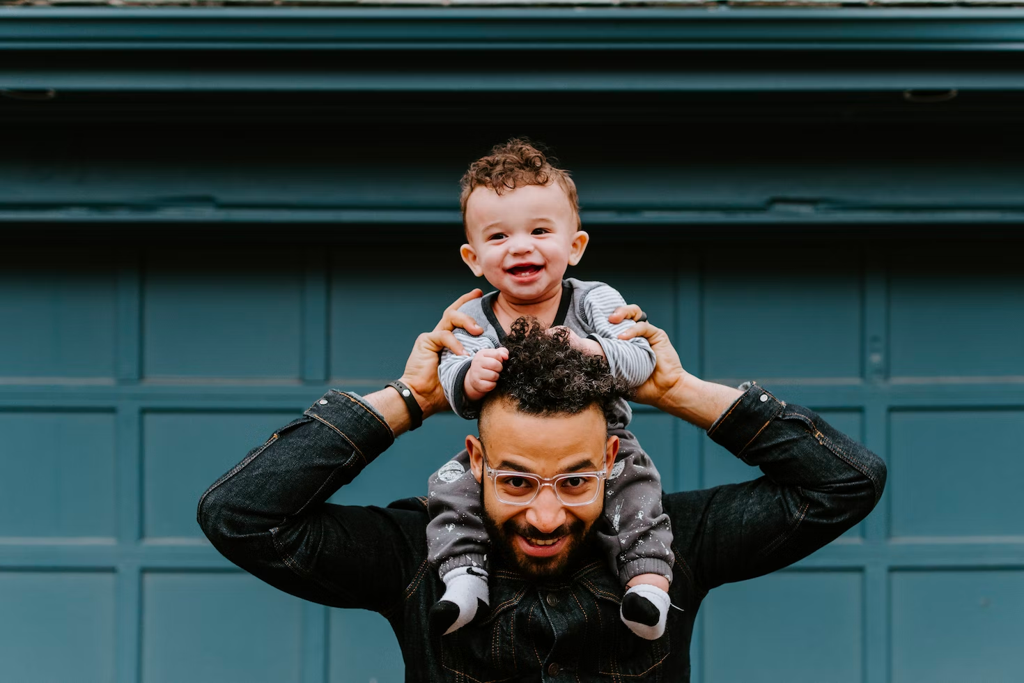 Young dad with baby on shoulders