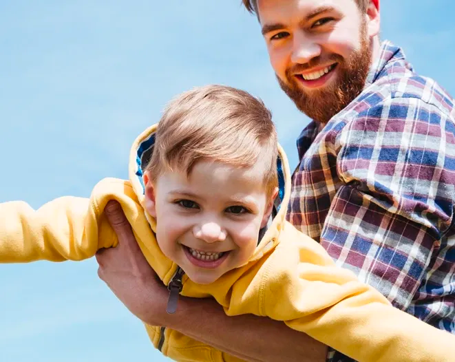 Girl on skateboard with young dad