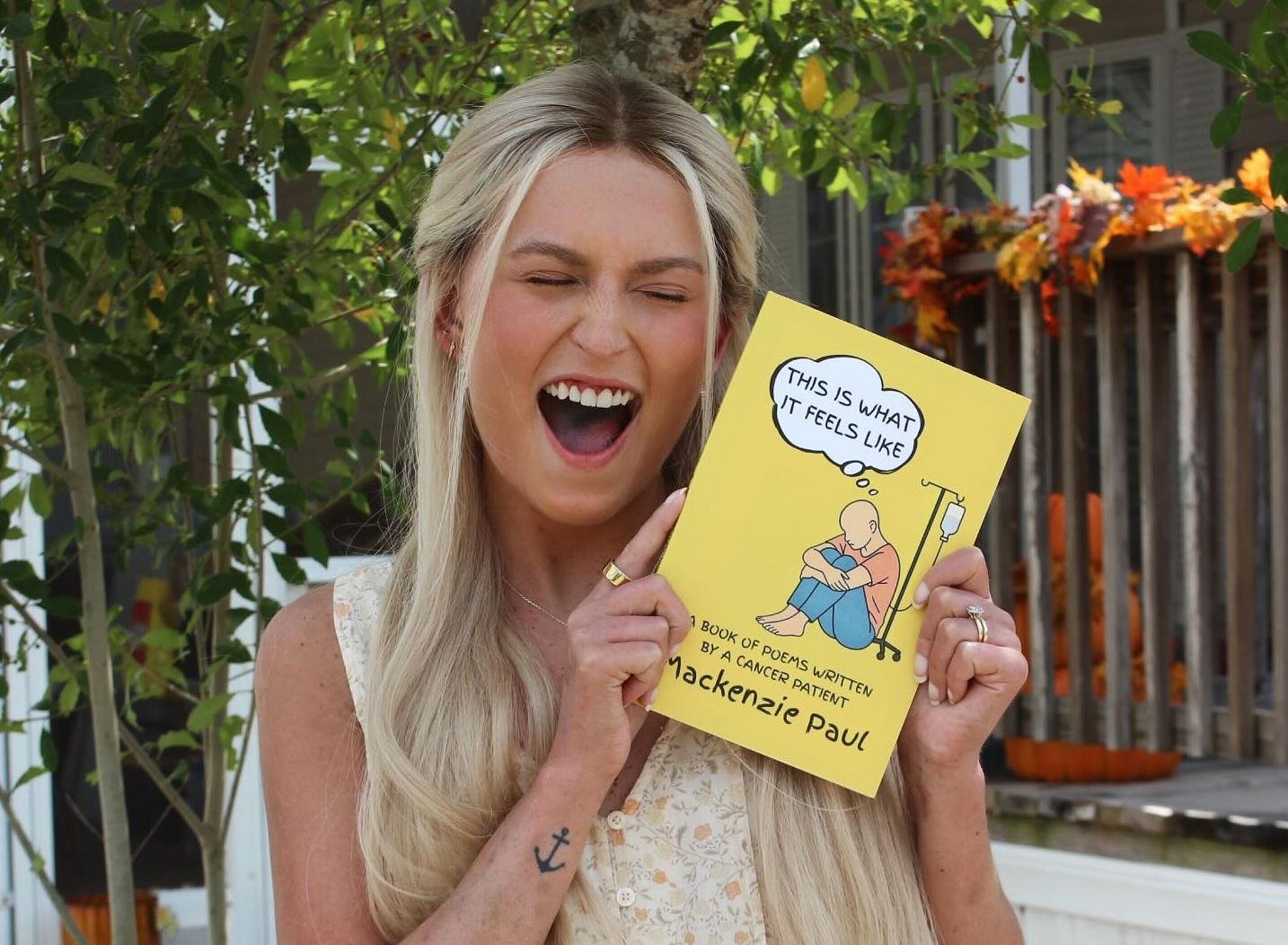 MacKenzie Paul holding her book