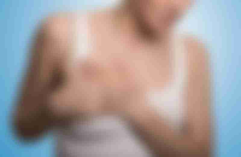 Woman Holding Breast