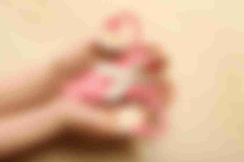 Woman with beige ribbon and paper uterus