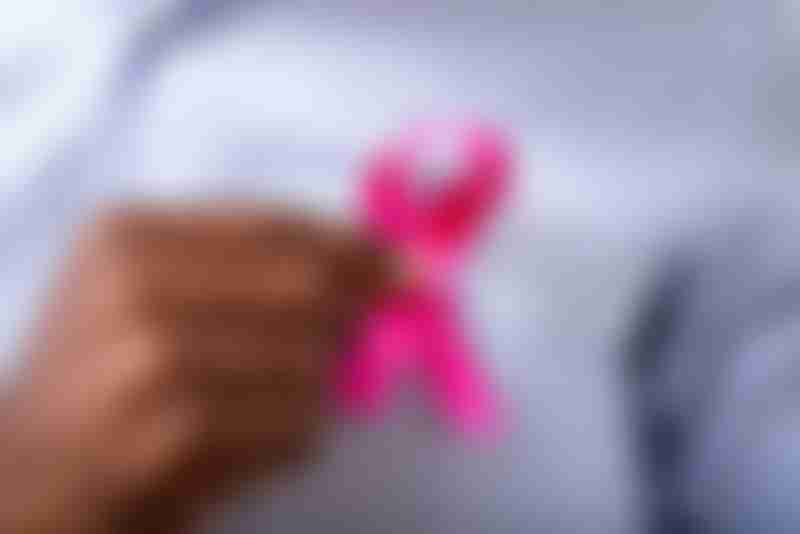Man Holding Pink Ribbon