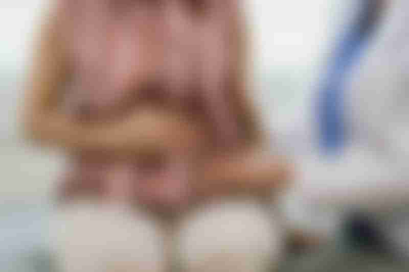 Doctor examines patient for liver cancer treatment risk