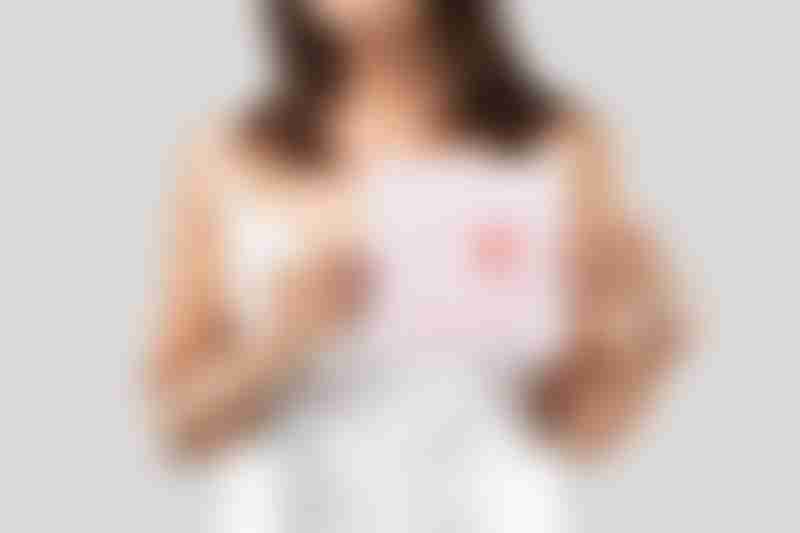 Woman Holding Image of Breast Cancer