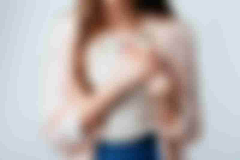 Young Woman Holding Breast