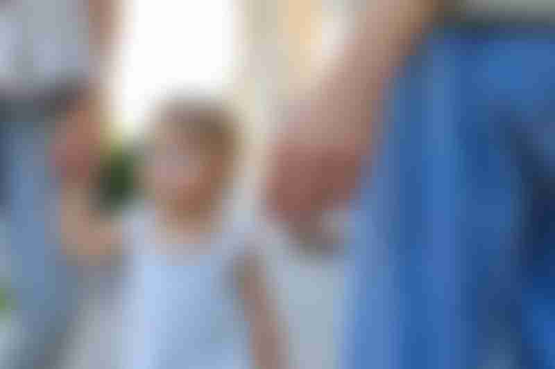 Smoker with Lit Cigarette Near Child