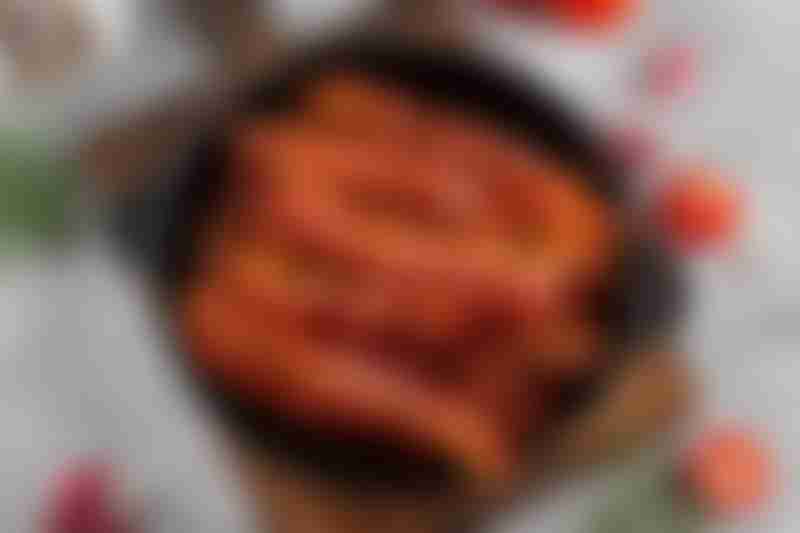 Fried slices of bacon for breakfast in a cast iron pan