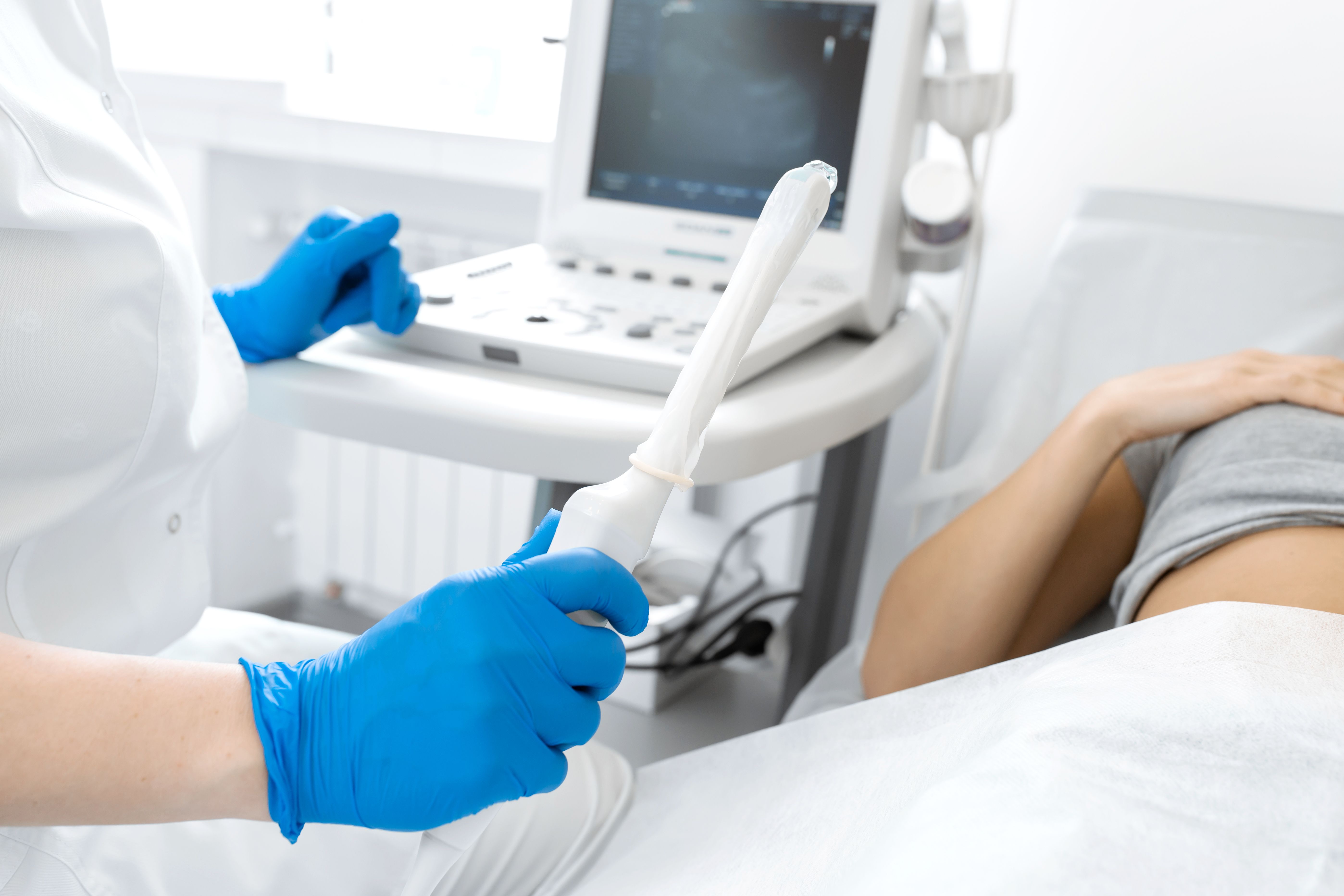 A gynecologist sets up an ultrasound machine