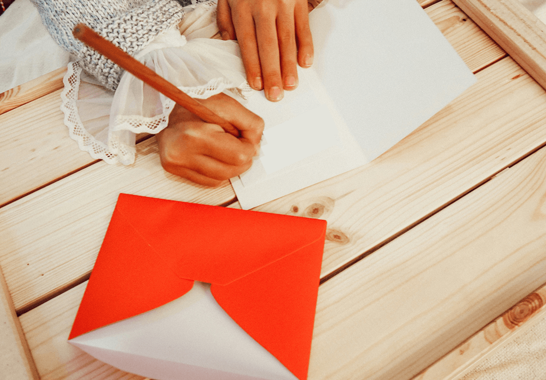 Girl writing support letter for donors