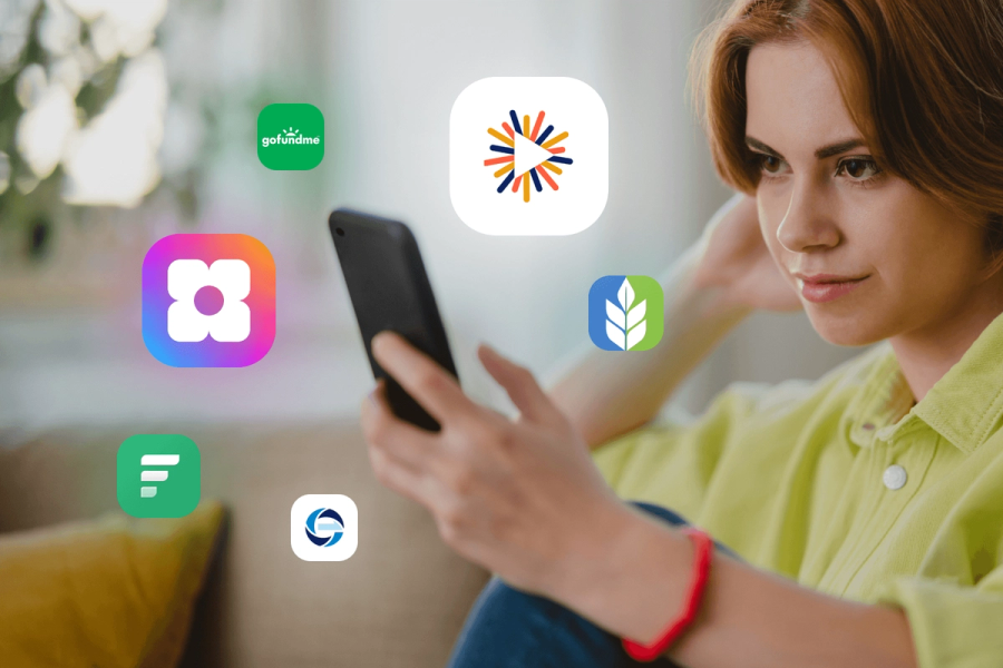 A woman looking at her phone surrounded by floating app icons including Sowfund, GoFundMe, and several other missionary fundraising platforms.