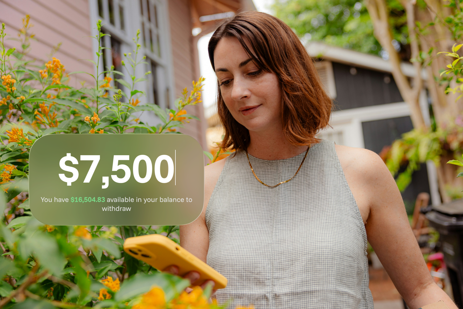 A woman stands outdoors among orange flowers, looking at her yellow-cased phone. A Sowfund overlay shows a $7,500 withdrawal entry field with a note that $16,504.83 is available in her balance.