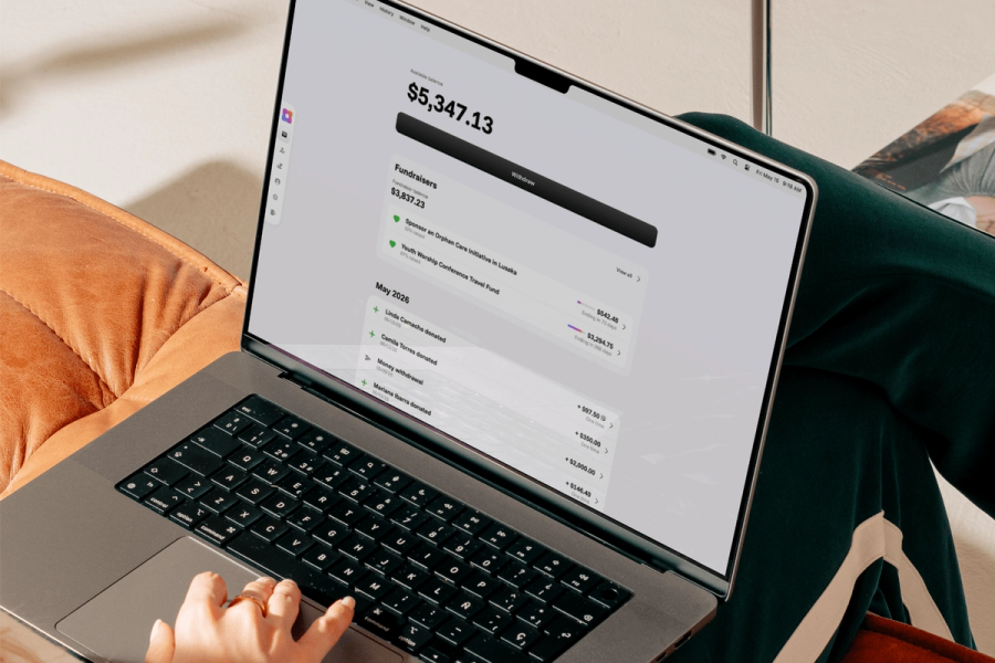 A person using a MacBook showing the Sowfund dashboard with an available balance of $5,347.13, active fundraisers, and a recent donation history including transactions from Linda Camacho, Camila Torres, and Mariana Ibarra.