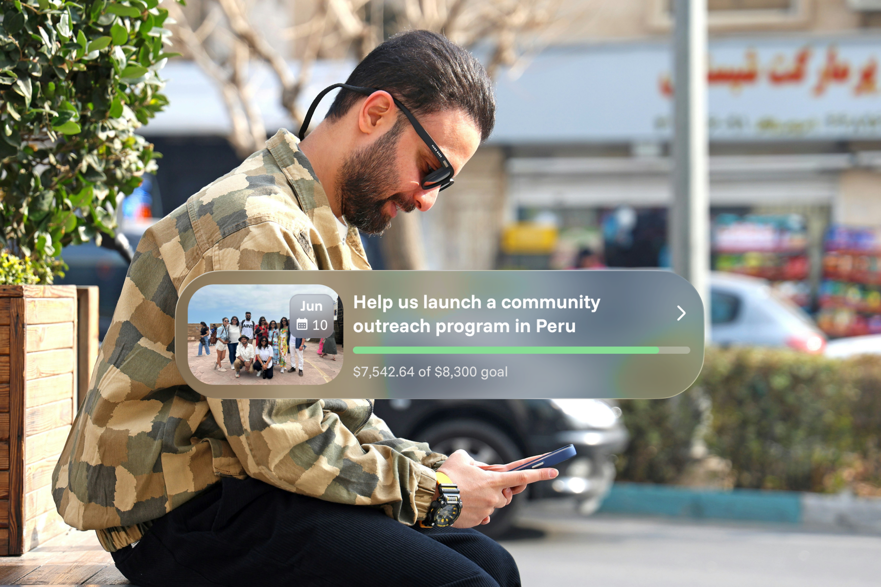 A man sits outdoors on his phone, with a Sowfund fundraiser card overlaid showing "Help us launch a community outreach program in Peru" — $7,542.64 raised of an $8,300 goal.