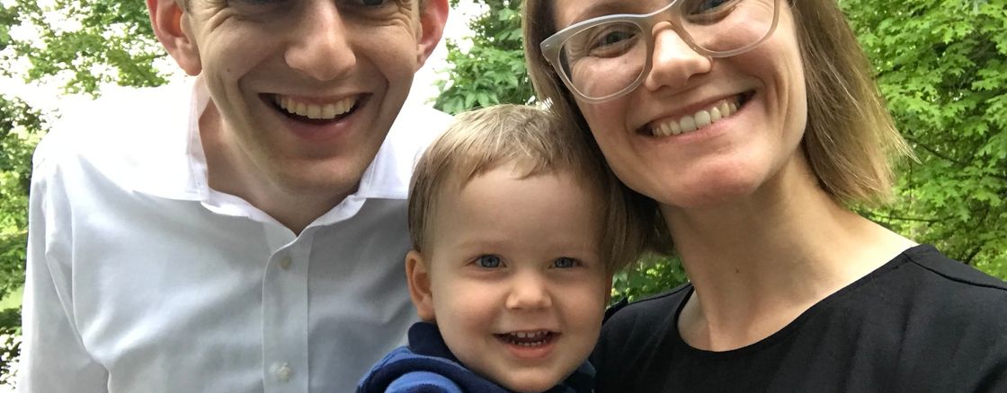 Family staring with kid pointing at camera