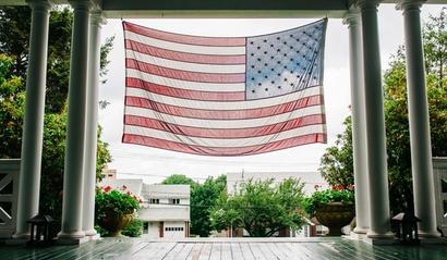 American flag hanging in front of a house on Veterans Day