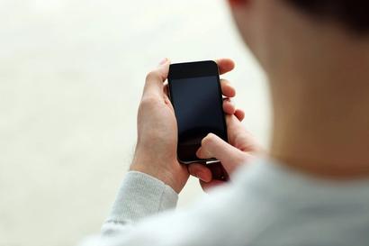 Man on old tiny iphone, hands too big, screen too small