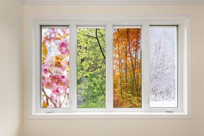 A window with four panes; each looking out to a different season