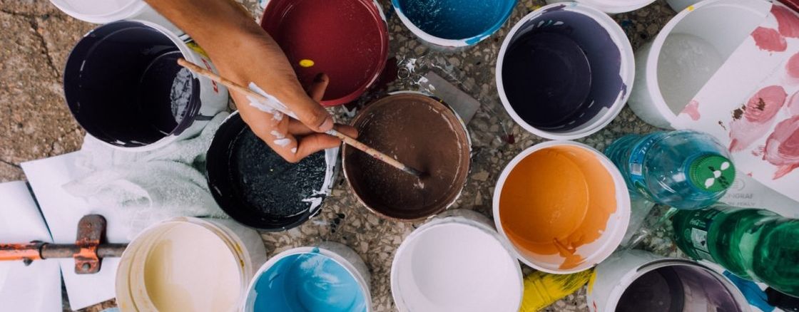 a painter choosing colors to paint with 