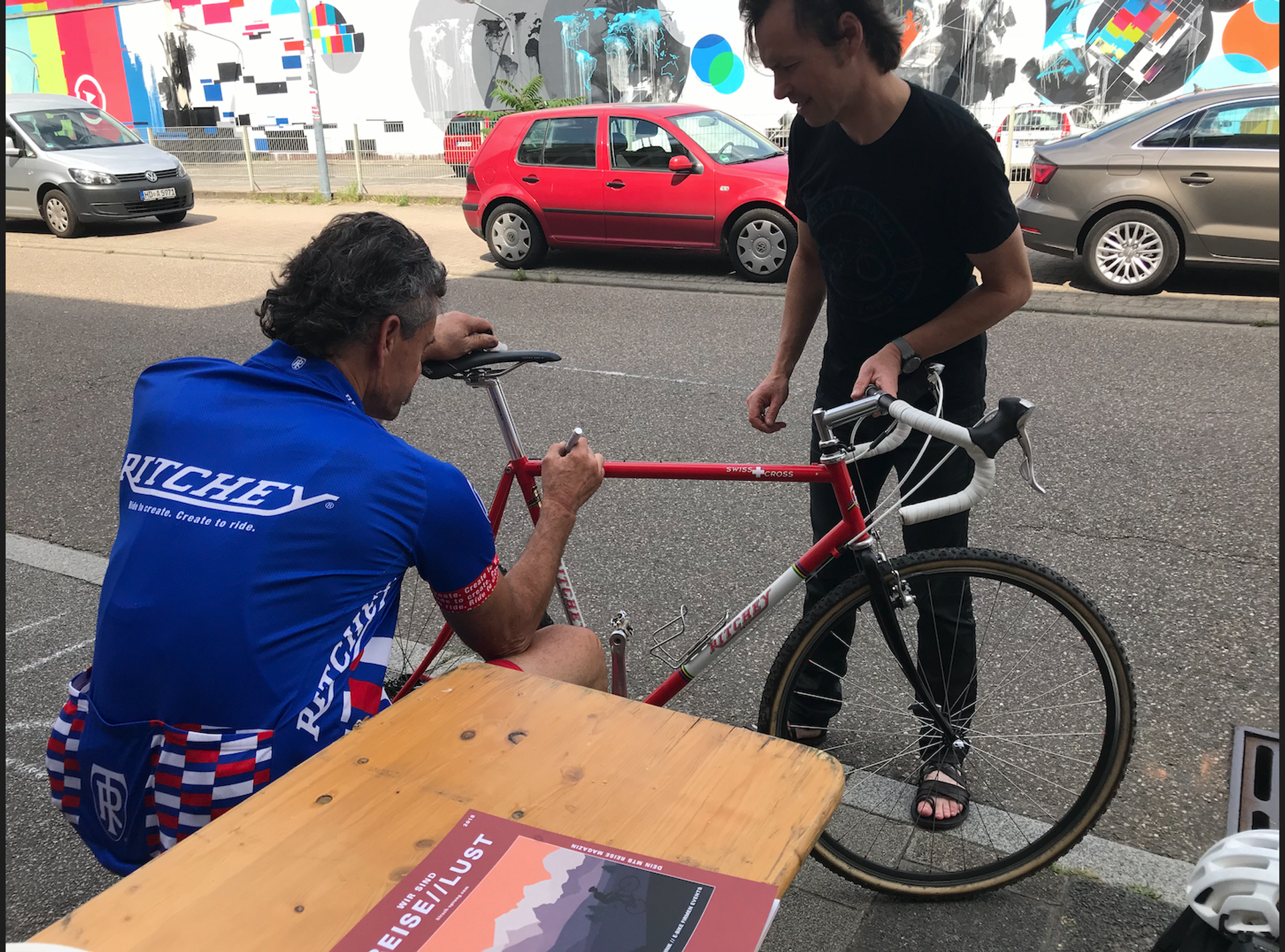 Tom Ritchey signing a bicycle in Germany.