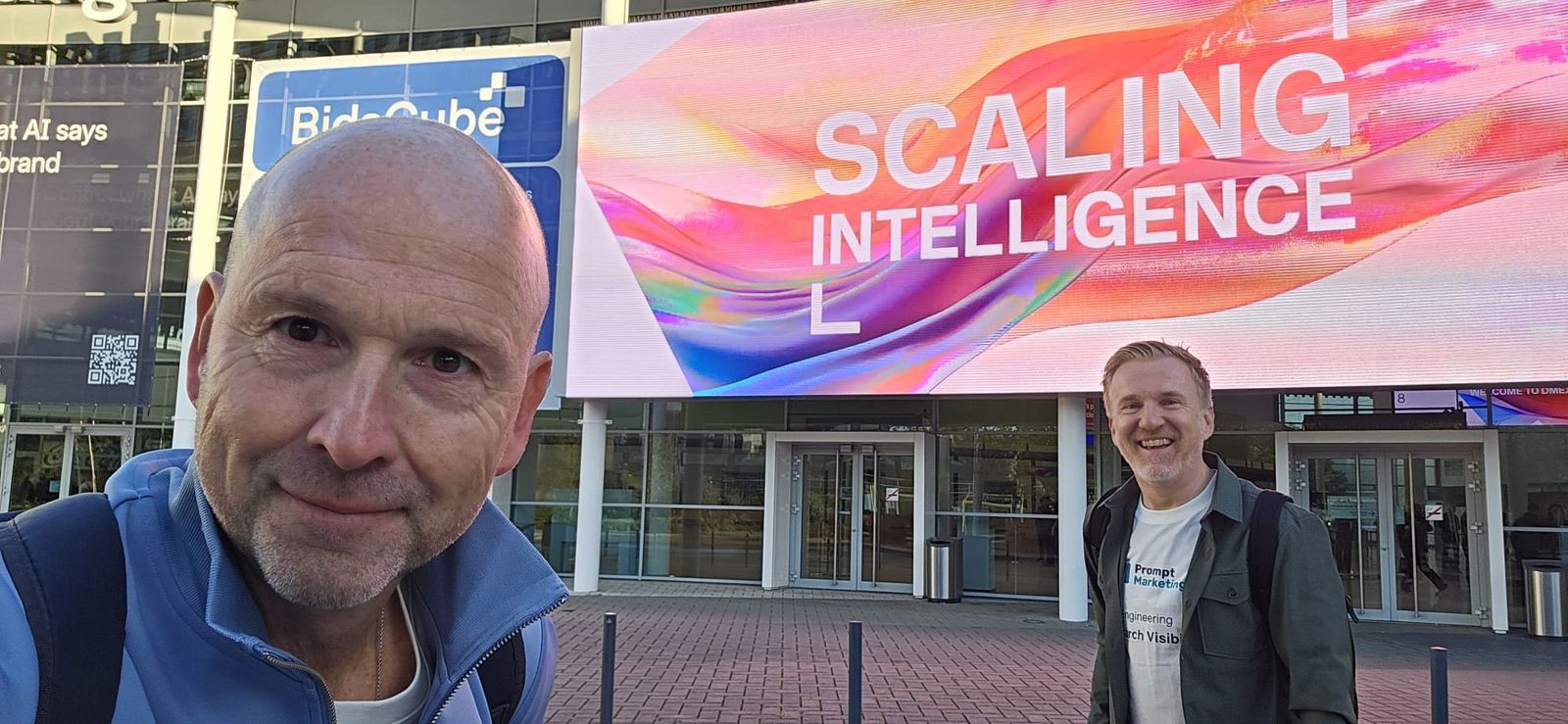 Erik Jan Reijenga and Arjan ter Huurne at the entrance of Koelnmesse under the DMEXCO 2026 theme Scaling Intelligence.