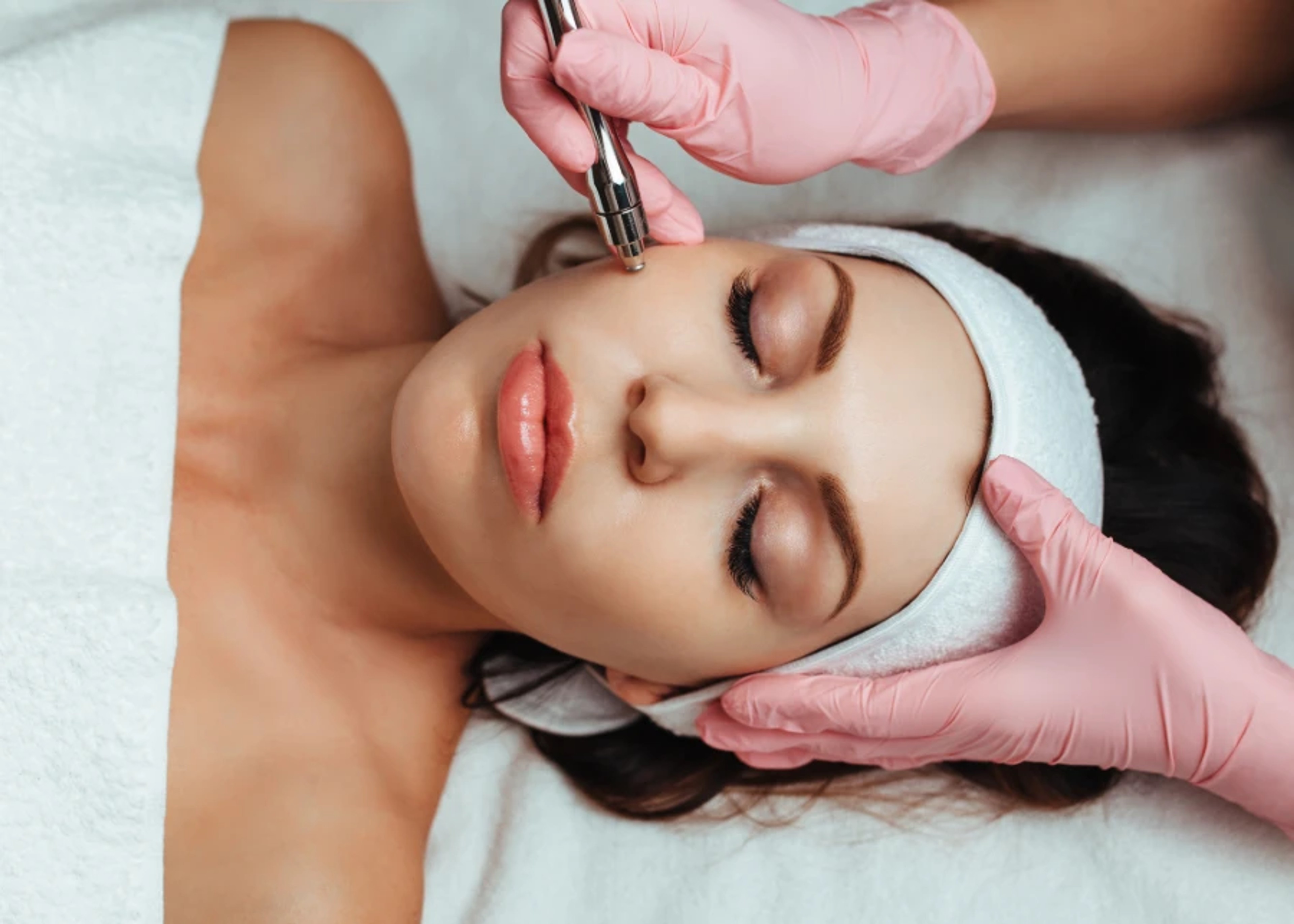 Disposable Pink Gloves used in facial treatment sessions for hygienic care.
