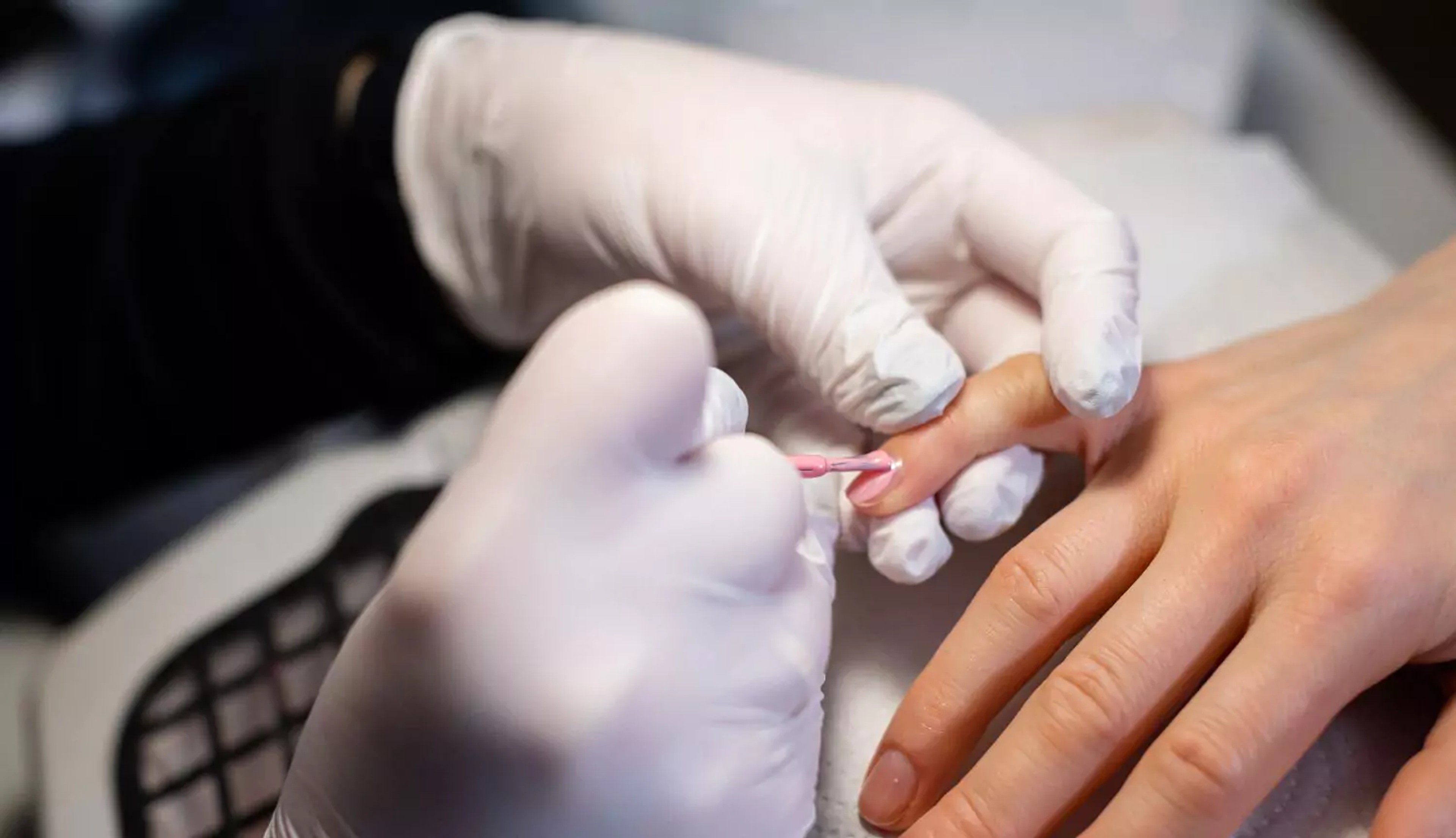 Synthetic latex gloves used during professional manicure service