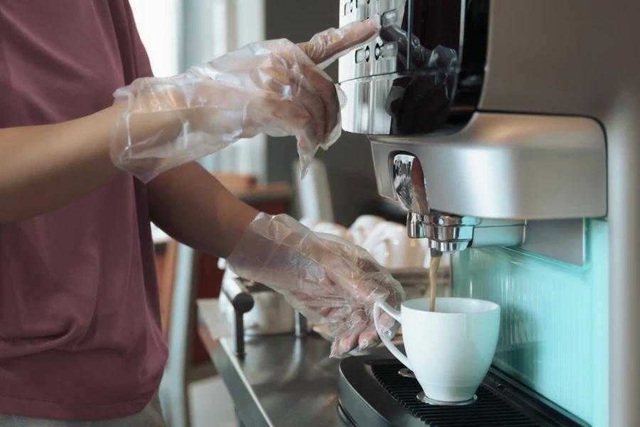 TPE Gloves used for safe coffee brewing at a modern espresso machine.