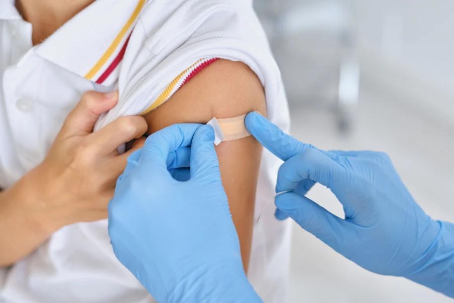 Disposable Gloves used in a medical setting for applying a bandage to a child's arm.